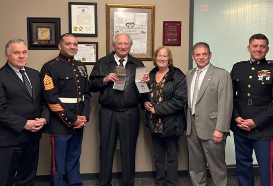 Cpl. Leo Perlmutter is presented with his Purple Heart medal during a ceremony at Rep. Smith’s Constituent Service Center. From left to right: Rep. Smith, SSGT Anthony Francisco, Cpl. Leo Perlmutter, Kathy Hoernlein, Peter Schneider, and Maj. Daniel Dennen.